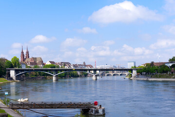 Fototapeta na wymiar Scenic landscape seen from City of Basel with Rhine River and bridge on a blue cloudy spring day. Photo taken April 27th, 2022, Basel, Switzerland.