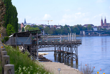 Open air bath named Rheinbad Breite with restaurant named Le Rhin Bleu (French, translation is the blue Rhine River) on a blue cloudy spring day. Photo taken April 27th, 2022, Basel, Switzerland.
