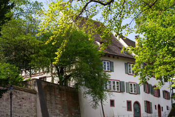 Alley with historic medieval houses at the old town of Basel on a sunny spring day. Photo taken April 27th, 2022, Basel, Switzerland.