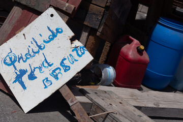 old sign prohibiting littering in a Spanish port 