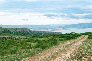 mountain landscape with dirt road in the vicinity of the reservoir of the Chirkey hydroelectric power station in Dagestan