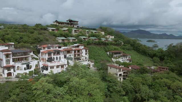 aerial drone shot tropical beach and hill settlements.
Danta Beach in Guanacaste, Las Catalinas town, Costa Rica.