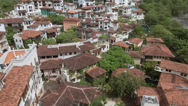 aerial drone shot tropical beach and hill settlements