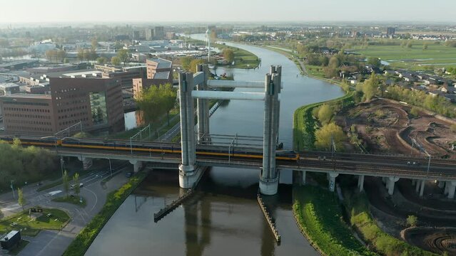 NS Intercity Materieel Traveling Through Railway Bridge From Gouda To Den Haag Centraal In Netherlands. - aerial