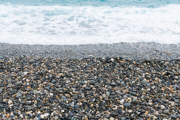 Waves crashing on the pebbled coast, the seaside of Qixingtan in Hualien, Taiwan