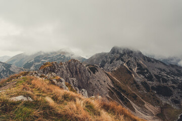 Obraz premium Misty and foggy morning on top of the hill Visevnik. Cloudy mountain panorama in the Julian Alps