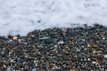 Waves crashing on the pebbled coast, the seaside of Qixingtan in Hualien, Taiwan