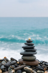 stacked stones, tower or pyramid of stones on the beach, balance, Sea waves background （Hualien, Taiwan）