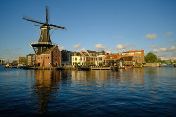 HAARLEM, NETHERLANDS - MAY 24, 2022: The famous Adriaan Windmill on the river De Spaarne on a clear day.
