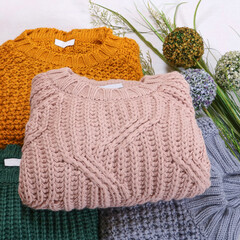 multi-colored sweaters on a white background. Stylish women's outfit