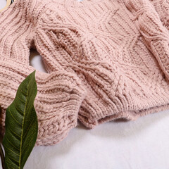 close-up of a knitted pink sweater on a white background. Stylish women's outfit