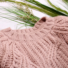 close-up of a knitted pink sweater on a white background. Stylish women's outfit