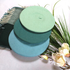 multi-colored berets on a white background. Stylish women's outfit