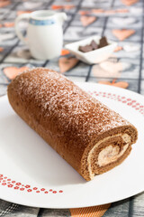 Swiss chocolate roll, stuffed with tiramisu cream sprinkled with cocoa and icing sugar