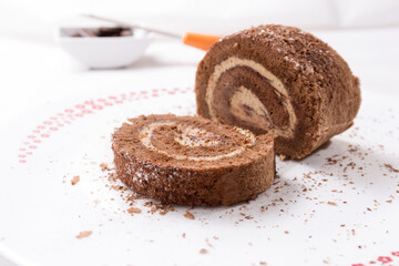 Swiss chocolate roll portion, filled with tiramisu cream dusted with cocoa and icing sugar