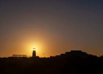 silhouettes of houses and people at sunset over the atlantic ocean from the portuguese fortress of Sagres 