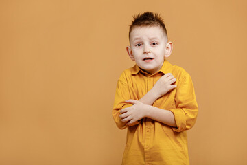 portrait of caucasian scared child boy on yellow background. amazed stressed boy in yellow shirt. school child afraid or shocked. surprised kid with fear and excited face. good and bad news