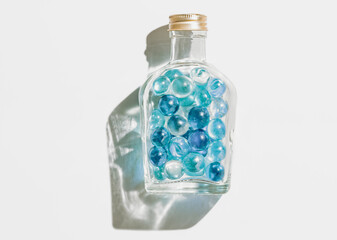 Fresh blue marble balls in a glass bottle, Cool summer background	