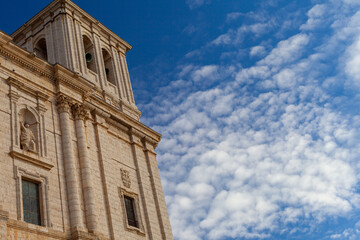 Fototapeta na wymiar front facade of a Spanish Catholic church with blue sky in the background