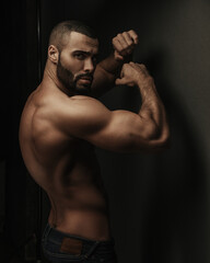 Profile portrait of fitness male model in studio with boxing pose