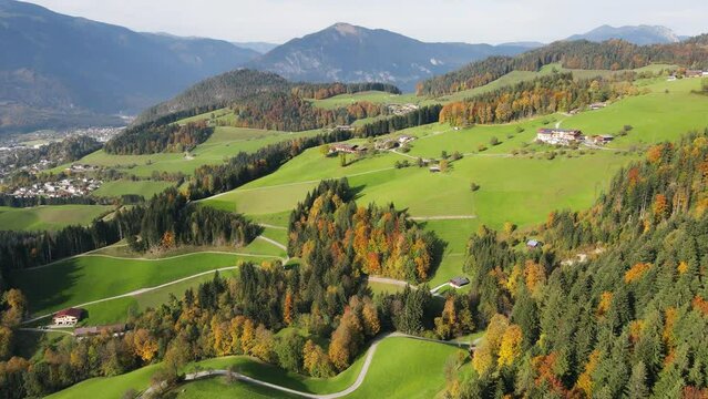 Drone shot of a beautiful autumn landscape and forest with Austrian farmhouses, Alpbach, Tyrol.