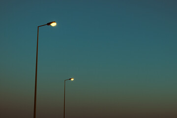 Fototapeta na wymiar Light poles in the blue sky
