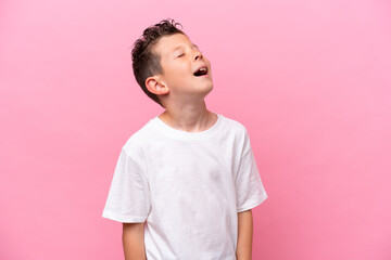 Little caucasian boy isolated on pink background laughing