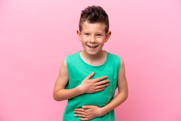 Little caucasian boy isolated on pink background smiling a lot © luismolinero