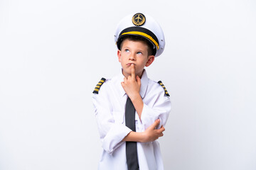 Little airplane pilot boy isolated on white background having doubts while looking up © luismolinero