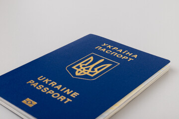 Ukrainian passport with a golden trident symbol on light background. Biometric Ukraine passport id empty place for photo or text.