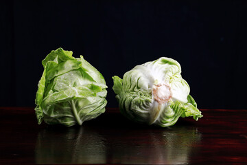 young fresh cabbage in the studio on a black background