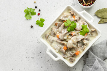 Slow cooker creamy chicken gizzards, giblets, offal. Top view, copy space.