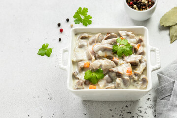 Creamy spicy chicken gizzard stew, giblets, offal. Top view, copy space.