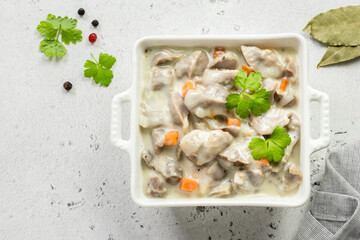Tender chicken gizzards, giblets, offal in cream sauce. Top view, copy space.