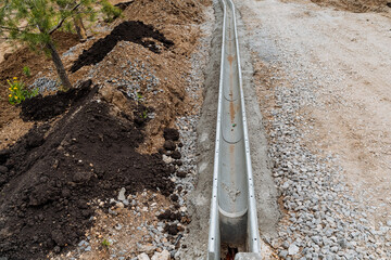 A direct rainwater drainage line, a sewage ditch, roadworks, asphalt laying, a layer of rubble on...