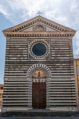 Fototapeta na wymiar The facade of the ancient church of San Francesco in the historic center of Prato, Italy