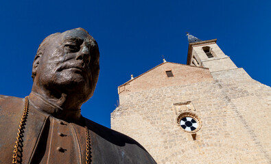 low angle of a statue of a bishop in front of a church