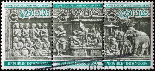 Bas relief of Borobudur monument on postage stamp of Indonesia - obrazy, fototapety, plakaty