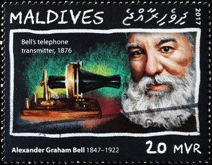 Bell's telephone transmitter and Graham Bell on stamp