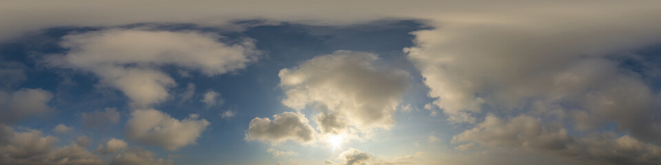 Panorama of a dark blue sunset sky with golden Cumulus clouds. Seamless hdr 360 panorama in spherical equiangular format. Full zenith for 3D visualization, sky replacement for aerial drone panoramas.