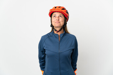 Middle age cyclist woman isolated on white background and looking up