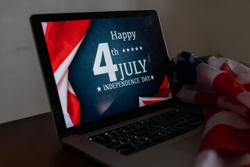 laptop with inscription 4 July inscription over american flag. Independence day.