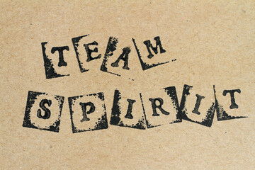 Text team spirit made with stamps on handmade brown paper
