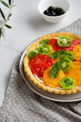 Close up of sliced heirloom tomato ricotta quiche on plate