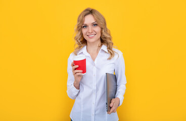 happy blonde woman with coffee cup and laptop on yellow background