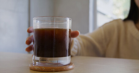 Woman enjoy her iced coffee in cafe