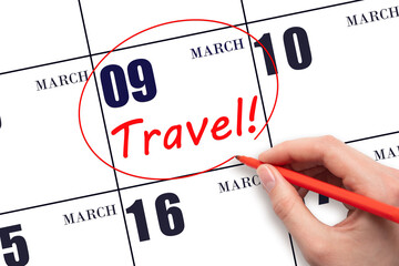 9th day of March. Hand drawing a red circle and writing the text TRAVEL on the calendar date 9...