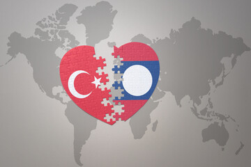 puzzle heart with the national flag of turkey and laos on a world map background. Concept.