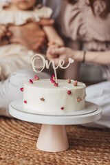 Birthday cake against family background. Family is blurred.