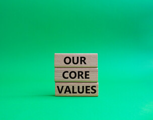 Our core values symbol. Concept words 'Our core values' on wooden blocks. Beautiful green background. Business and Our core values concept. Copy space.